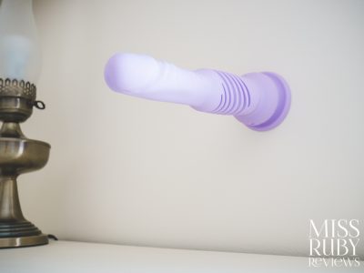 The Velvet Mini Thruster stuck to a wall using its suction cup